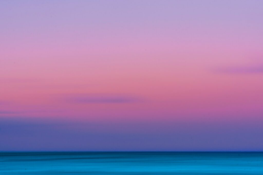 calm body of water with orange sky